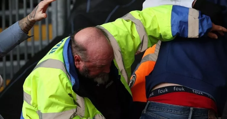 1_PAY-Swansea-UK-07th-Apr-2023-A-fight-in-the-stand-between-a-Coventry-city-fan-l-and-Swansea-city-f